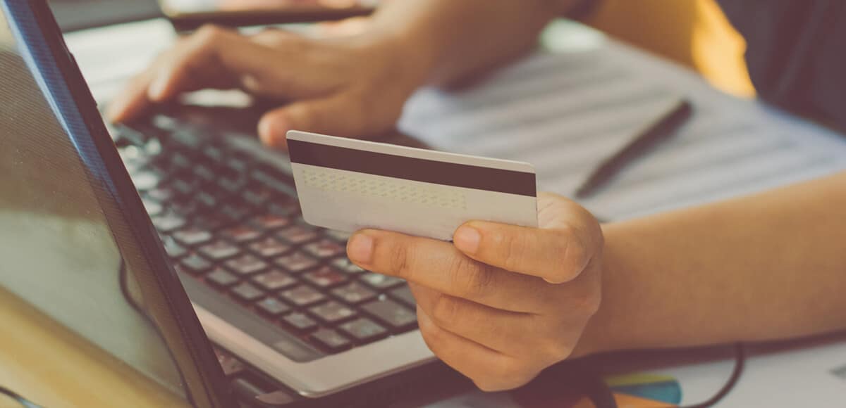 person holding credit card and ordering from an online store